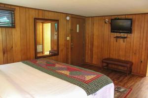a bedroom with a bed and a flat screen tv at Shady Brook #544 in Sevierville