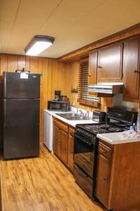 a kitchen with a black refrigerator and a sink at Shady Brook #544 in Sevierville +15 photos