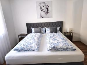 a bedroom with a bed with blue and white pillows at MY HOME N 35/6 in Villingen-Schwenningen