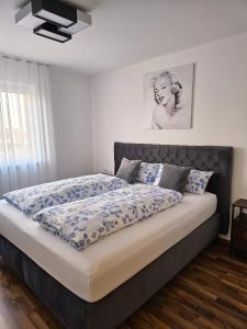 a bedroom with a large bed with blue sheets at MY HOME N 35/6 in Villingen-Schwenningen
