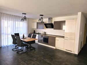 a kitchen with a table and chairs in a room at MY HOME N 35/6 in Villingen-Schwenningen