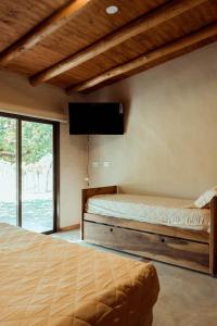 Una cama o camas en una habitación de Posada Bonarda San Rafael