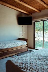 Una cama o camas en una habitación de Posada Bonarda San Rafael