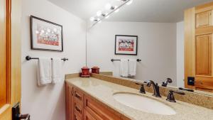 a bathroom with a sink and a mirror at Woodrun Place in Snowmass Village