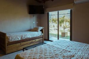 Una cama o camas en una habitación de Posada Bonarda San Rafael