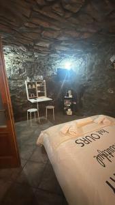 Habitación con cama en una pared de piedra. en La Grotta di Leonardo a Vinci, en Quarrata