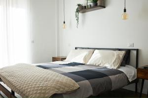 a bed with a black and white comforter in a bedroom at Plebiscito Old Fashion in Castel di Sangro