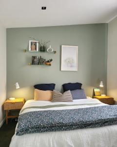 a bedroom with a large bed with pillows on it at Artist Photographers Home Studio in Auckland