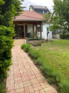 a house with a brick walkway in front of it at Tulipános Ház in Badacsonytomaj