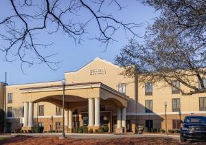 een gebouw met een auto ervoor geparkeerd bij Russell Inn and Suites in Starkville