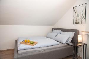 a bed with a tray with drinks on it at Neue Ferienwohnung in Marl in Marl