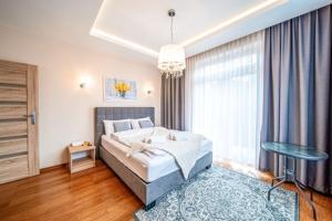 Posteľ alebo postele v izbe v ubytovaní Apartament Szymanowskiego