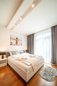 Posteľ alebo postele v izbe v ubytovaní Apartament Szymanowskiego