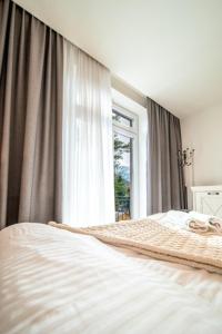 Posteľ alebo postele v izbe v ubytovaní Apartament Szymanowskiego