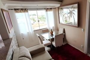 a living room with a couch and a table at Cobertura Pôr do Sol Saquarema in Saquarema