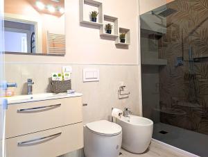 a bathroom with a toilet and a sink and a shower at Maison del Ducato Suite Correggio in Parma +34 photos