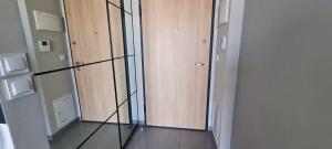 a room with a glass partition with a door at Metro Modern Warsaw Apartments in Warsaw