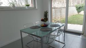 a dining room table with chairs and a table with fruit on it at Dom na Červenej Veži in Banka