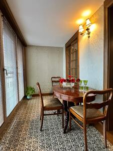 a dining room with a wooden table and chairs at Apartament Luca in Krakow