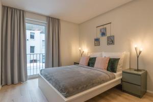 a bedroom with a bed and a large window at Wiesbaden Business Appartement in Wiesbaden