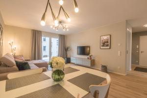 a living room with a couch and a table at Wiesbaden Business Appartement in Wiesbaden