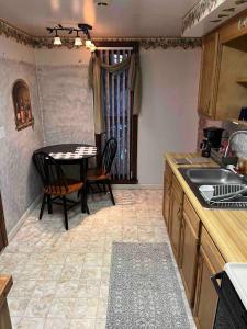 a kitchen with a table and chairs and a sink at Cozy, Pet-friendly Ligonier in Ligonier