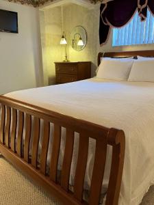 a bedroom with a large bed and a window at Cozy, Pet-friendly Ligonier in Ligonier