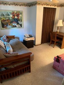 a living room with a couch and a table at Cozy, Pet-friendly Ligonier in Ligonier