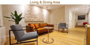 a living room with a couch and a table and chairs at Dein Chill-Space mitten in Hannover in Hannover