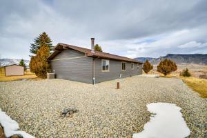 a house with a gravel driveway in front of it at Rural Cody Vacation Rental about 10 Mi to Downtown! in Cody