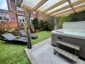 a backyard with a hot tub and a patio with at Freeman Hot Tub House, Free Parking, Transport Links in Longbenton
