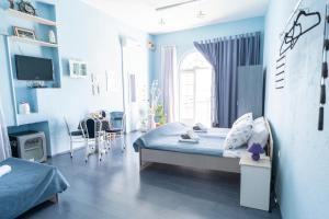 a blue bedroom with a bed and a dining room at Pension More in Šibenik