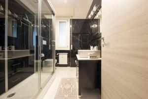 a bathroom with two sinks and a glass shower at Exclusive with Jacuzzi between Portofino and 5 Terre in Chiavari