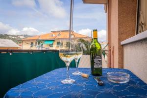 a table with a bottle of wine and a glass at Exclusive with Jacuzzi between Portofino and 5 Terre in Chiavari