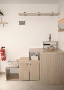a wooden counter with a microwave on top of it at Medizen Apartment in Izola
