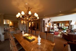 a dining room with a wooden table with fruit on it at Ness Castle Lodges in Inverness