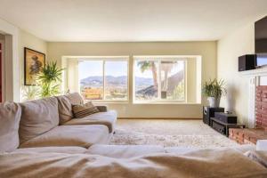 a living room with a couch and a large window at Santa Clarita Mountain Top in Santa Clarita