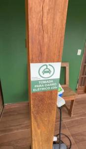 a surfboard standing in a room with a sign on it at Pouso da Paz in Tiradentes
