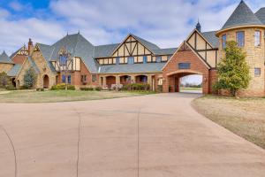 a large brick house with a large driveway at Spacious Edmond Vacation Rental with Shared Pool! in Edmond