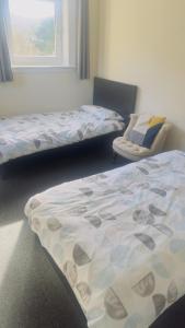 A bed or beds in a room at Budget Rooms