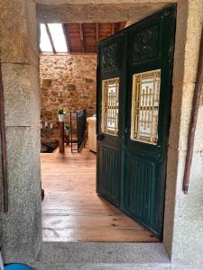 an open door in a room with a wooden floor at QUINTA DO CAMBEIRO in Viana do Castelo