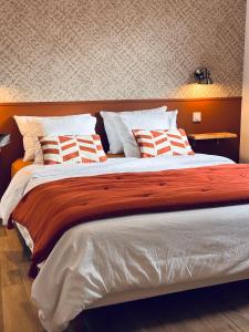 a bedroom with a large bed with pillows on it at Chez François et Cécile in Figari