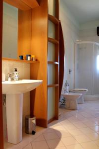 a bathroom with a sink and a toilet at Villa Sam in Comiso