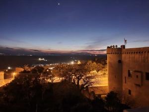 a view of a castle at night at B&B Palazzo Croghan in Torremaggiore