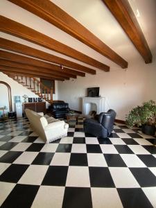 a living room with a black and white checkered floor at Costa Esperanza MDQ in Mar del Plata