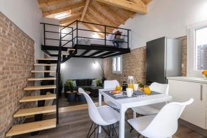 a kitchen and dining room with a spiral staircase in a loft at Jonas port house in Ágios Rókkos