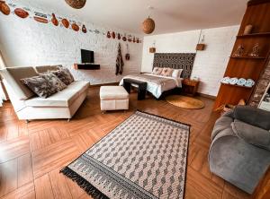 La Floresta Hotel في بانوس: غرفة معيشة مع أريكة وطاولة
