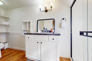 a bathroom with a sink and a mirror at Fountain District Bungalow in Bellingham +9 photos