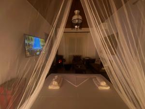 a view of a room with a bed with curtains at Camarina Sea View in Kamarína