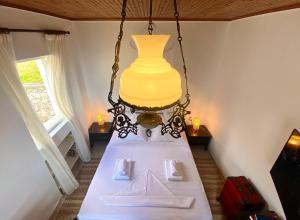 a dining room table with a yellow vase hanging from a ceiling at Camarina Sea View in Kamarína